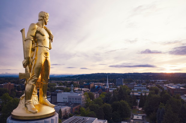 Photo of gold man statue atop the Oregon State Capitol building