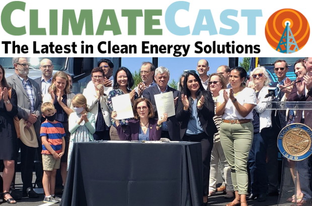 oregon gov kat brown signing 100% clean electricity law surrounded by supporters 
