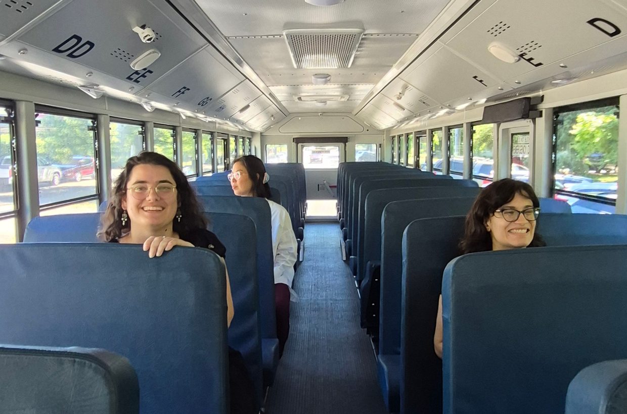 Climate advocates happily riding a clean school bus.