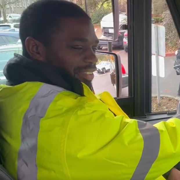 Photo of Highline SD bus operator Theo White behind the wheel of an electric school bus