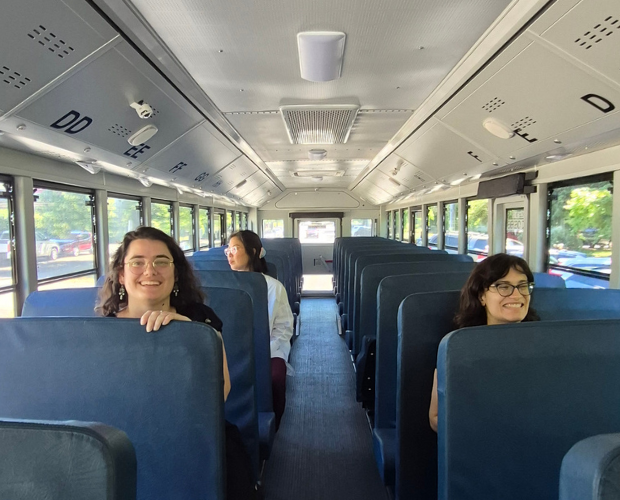Climate advocates happily riding a clean school bus.