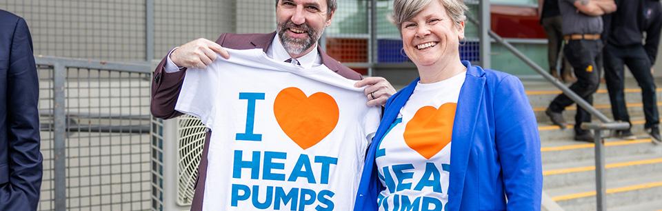 image of two folks holding up I love heat pump shirts