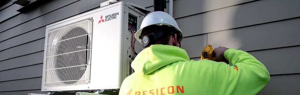 image of technician installing a heat pump