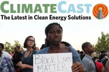 woman holding black lives matter sign in a crowd 