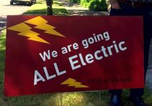 Yard sign that reads "We are going all electric"