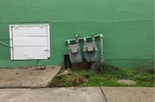 green wall with gas meter in the center