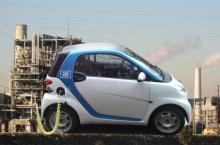 Electric car charging, plugged into power plant