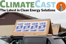 Photo of UAW union signs atop a minivan