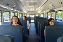 Climate advocates happily riding a clean school bus.