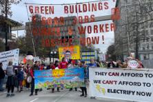 protest march in downtown seattle, protesters holding signs in support of seattle's green new deal