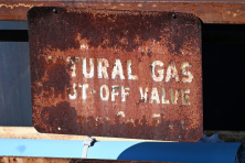 image of a rusted natural gas shut off sign