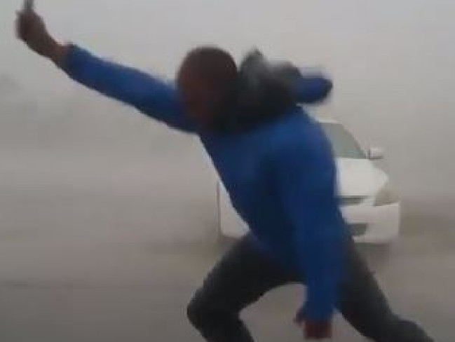 Meteorologist in a hurricane