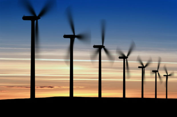 Windmills spinning at sunset